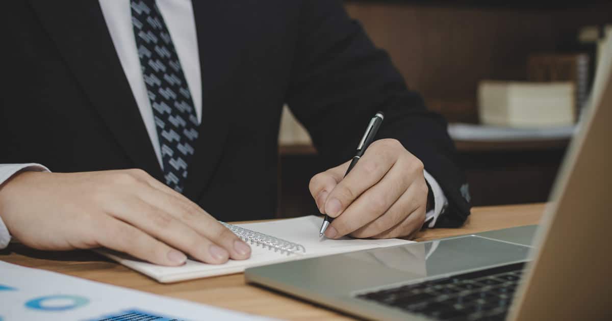 Lawyer at desk on remote deposition
